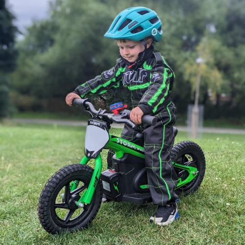 Child riding a bright green 12