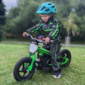 Child riding a bright green 12" electric balance bike